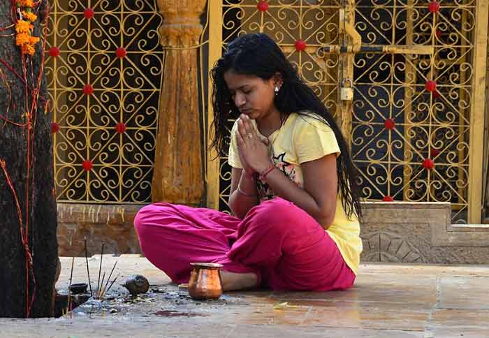 Woman praying and burning incense
