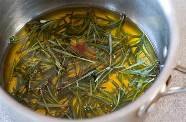 heating rosemary leaves in a pan of oil
